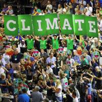 Members of Germany’s Greens party hold a banner reading “Climate first” during a party congress in Berlin on June 17. U.S. officially informs U.N. it wants to get out of Paris climate deal