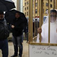 An activist from the Lebanese NGO Abaad stands in a golden cage dressed as a bride during a protest in front of the government building in downtown Beirut in March. On Wednesday parliament repealed a law that allowed rapists to avoid prison by marrying their victims, which had been in place since the 1940s, and follows years of campaigning by women’s rights advocates. Lebanon drops law that let rapists off hook if they married their victims