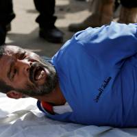 Muhammad al-Maghrabi, 41, who was convicted of raping and murdering a 3-year-old girl, reacts as he is prepared to be executed in Sanaa Monday. | REUTERS