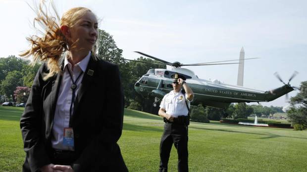 U.S. Secret Service agents stand guard as Marine One, with President Donald Trump on board, departs the White House in Washington on July 22. U.S. Secret Service unable to pay 1,100 employees for overtime due to cost of protecting Trump