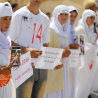 Yazidis attend a commemoration to mark three years since Islamic State launched what the United Nations said was a genocidal campaign against them, in Sinjar region, Iraq, Thursday. | REUTERS
