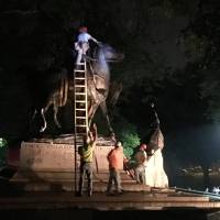 Workers remove the monuments to Robert E. Lee, commander of the pro-slavery Confederate army in the American Civil War, and Thomas “Stonewall” Jackson, a Confederate general, from Wyman Park in Baltimore early Wednesday. Baltimore 'quickly and quietly' removes four Confederate statues after deadly Virginia rally