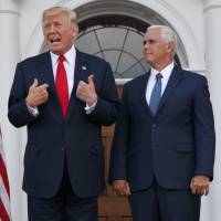 President Donald Trump, accompanied by Vice President Mike Pence, speaks to reporters before a security briefing on Thursday at Trump National Golf Club in Bedminster, New Jersey. Trump's Venezuela comments pose challenges for Pence