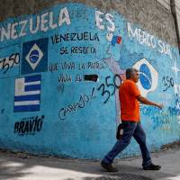 Graffiti reading \"Venezuela is Mercosur, Venezuela is respected and live long the homeland\" stands in Caracas on Saturday. | REUTERS