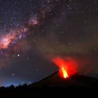 Hot lava flows down the Mount Sinabung volcano Sunday night in Karo, North Sumatra, Indonesia. | AFP-JIJI