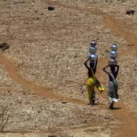 Indian women walk home after collecting drinking water from a well at Mengal Pada in Thane district in Maharashtra state, India, in May 2016. A new study suggests wide swaths of northern India, southern Pakistan and parts of Bangladesh may become so hot and humid by the end of the century it will be deadly just being outdoors. Such conditions would threaten up to a third of the 1.5 billion people living in those regions, unless the global community can rein in climate-warming carbon emissions. Venturing outdoors in South Asia at end of century will be deadly due to heat, humidity: study