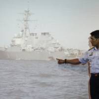 Malaysian Maritime Director Indera Abu Bakar points the damage of the USS John S. McCain shown on a screen during a press conference in Putrajaya, Malaysia, Monday. Questions abound about how U.S. warship, tanker could have collided in Singapore waterway