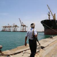 A soldier patrols a pier at the Red Sea port of Hodeidah, Yemen, in May. | REUTERS