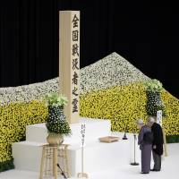 Emperor Akihito and Empress Michiko bow before an altar decorated with a bank of chrysanthemums during a memorial service at Nippon Budokan hall in Tokyo on Tuesday as Japan marked the 72nd anniversary of its World War II surrender. Over 6,100 offer prayers for war dead at event marking 72nd anniversary of Japan's WWII surrender