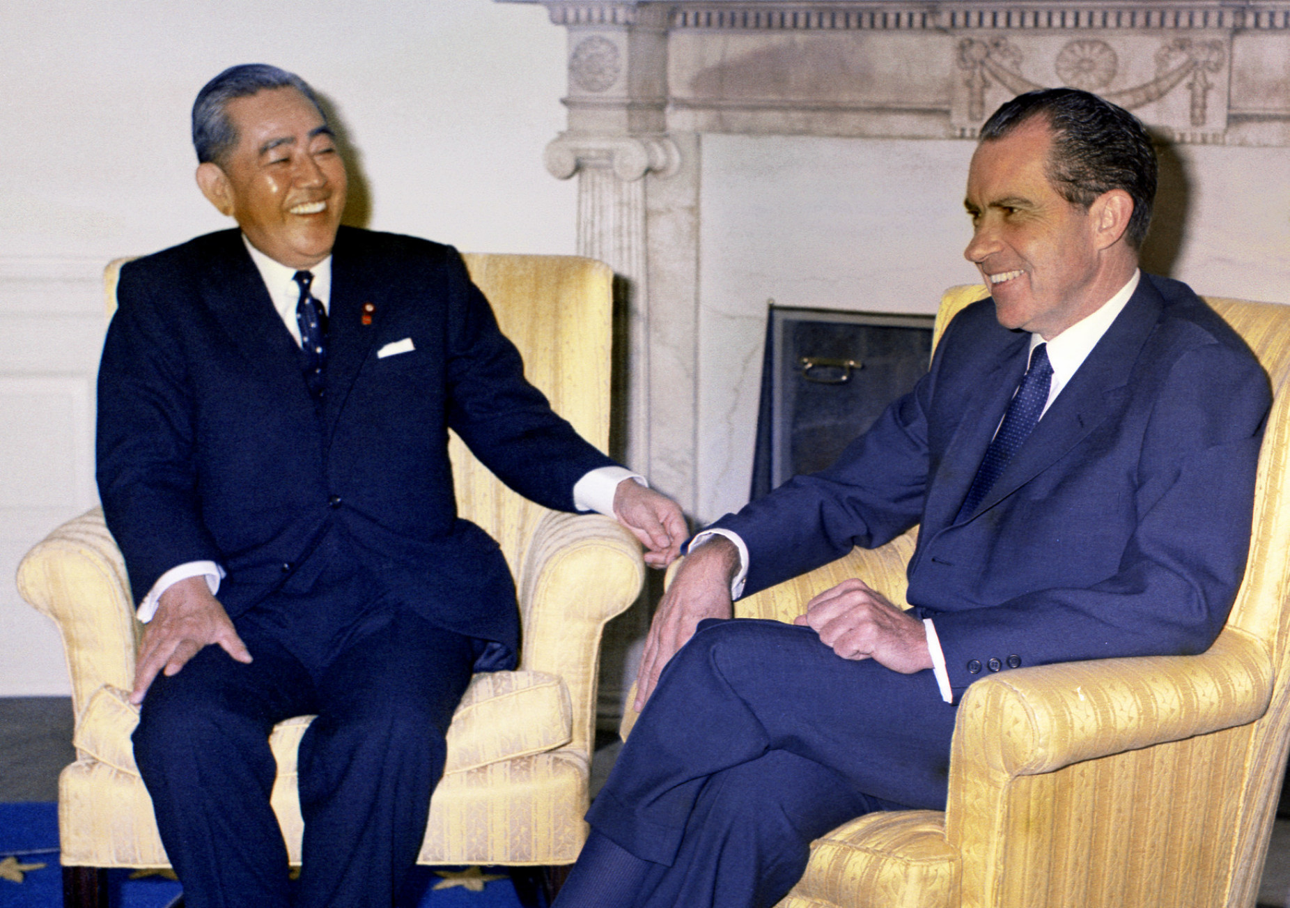 Prime Minister Eisaku Sato meets with U.S. President Richard Nixon at the White House in November 1969. The two later agreed to have Okinawa revert to Japanese rule. | KYODO