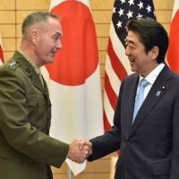 Gen. Joseph Dunford, chairman of the U.S. Joint Chiefs of Staff, shakes hands with Prime Minister Shinzo Abe at Abe’s official residence in Tokyo on Friday. Top U.S. general reaffirms commitment to Japan amid North Korea tensions