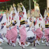 A dance team shows off its moves during the annual Awa Odori festival in the city of Tokushima on Saturday. Crowds expected as Tokushima's Awa Odori festival adds foreign amenities