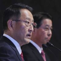 Toyota Motor Corp. President Akio Toyoda (left) and Mazda Motor Corp. President Masamichi Kogai answer a question at a news conference in Tokyo on Friday. Global shift to EVs fuels Toyota-Mazda tie-up