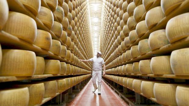 A worker inspects wheels of Parmigiano Reggiano cheese at a storehouse in Modena, Italy, in February 2016. Some Japanese brand legacies stand to profit from geographical indication; others, not so much