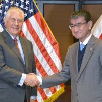 U.S. Secretary of State Rex Tillerson and Foreign Minister Taro Kono greet each other in Manila Monday on the sidelines of the regional meeting involving foreign ministers from the Association of Southeast Asian Nations (ASEAN). | KYODO