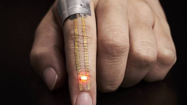 Electric current from a battery placed near the knuckle flows through the conductor and powers an LED near the fingertip. Japan's scientists develop superthin nano sensors that may be the next big advance in wearable tech