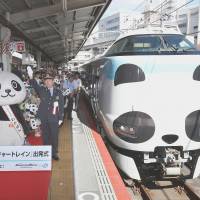 A Kuroshio limited express train repainted to resemble the face of a giant panda departs from JR Tennoji Station in Osaka on Saturday. | KYODO