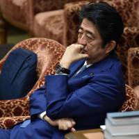 Prime Minister Shinzo Abe attends a February budget committee session of the House of Representativest in Tokyo. Less than six months ago Abe appeared poised to stay in power until 2021, becoming Japan’s longest-serving leader and cementing a coveted place in history. Now, the humbled hawk finds himself fighting for his political life or, in the words of one observer, scrambling to crawl out of a “hell hole.” Opposition camp fears Abe may call snap election in October
