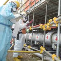Tepco workers begin work on Tuesday to circulate coolant for the remaining section of a 1.5-kilometer-long, 30-meter-deep wall around the four damaged reactor buildings of the Fukushima No. 1 nuclear power plant. Tepco begins extending ice wall to reduce tainted water at Fukushima plant