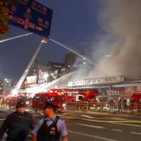 Fire trucks are seen lined up on the main road close the famed Tsukiji fish market in central Tokyo late Thursday afternoon after a fire broke out. There were no reports of any injuries. | KAZUHIRO KOBAYASHI