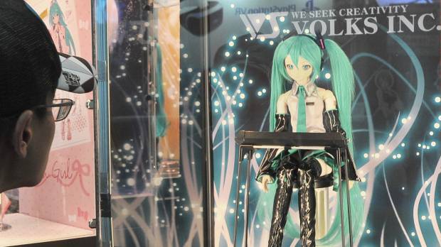 Digital voice: A fan looks at a Hatsune Miku doll at last year’s Magical Mirai event at the Makuhari Messe convention center in Chiba Prefecture. Animated pop star Hatsune Miku is only 10, but she has had a huge impact on music