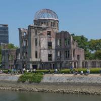 Unforgettable: Tourists pass the Atomic Bomb Dome in Hiroshima. | STEPHEN MANSFIELD