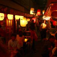 Night lights: Kagoshima’s Kagomme Furusato Yataimura stalls have local fare and faces. Drinking to health and history in Kagoshima