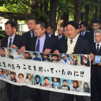 Justice bound: Parents of children who died in the tsunami at Okawa Elementary School in Ishinomaki, Miyagi Prefecture, walk to the Sendai District Court in October 2016, where they would learn their claim of damages for negligence by the local government had won. The verdict is presently being appealed. 'Ghosts of the Tsunami': Richard Lloyd Parry's careful recounting of the 2011 tsunami and what came after