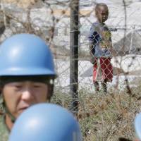 Out of Africa: Ground Self-Defense Force members of the U.N. Mission in South Sudan (UNMISS) work beside a refugee camp in the South Sudanese capital of Juba in November. The mission wrapped up in May. Lawyers attempt to fill in the gaps in the GSDF's heavily redacted South Sudan PKO logs