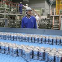 Asahi Breweries plant manager Shinichi Uno watches the production line at an Asahi Breweries factory in Moriya, Ibaraki Prefecture. Much of the work once performed by people at the factory has been taken over by machines. As Japan’s population shrinks, the country must accept more immigrants or make greater use of robots, and the latter is the favored solution. Japan's booming and now needs more immigrants