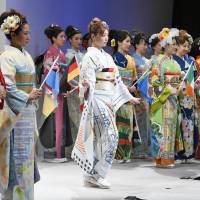 Diplomatic dress: Models at a Tokyo runway show on Oct. 30, 2016, showcase some of the Imagine Oneworld Kimono Project creations, which are each dedicated to different countries. World kimono project aimed to revitalize crafts has three years to go