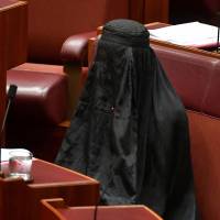 Sen. Pauline Hanson, leader of the Australian One Nation party, wears a burqa in the Senate chamber at Parliament House in Canberra on Aug. 17 to push for a ban on the garment. Islamic dress codes and liberal democracy