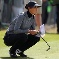 Michelle Wie lines up a putt during the first round of the Women’s British Open on Thursday in St. Andrews, Scotland. Wie sets course record at Women's British Open; Miyazato eight shots back