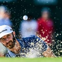 Dustin Johnson hits out of the bunker on the 17th hole during the final round of the Northern Trust on Sunday in Old Westbury, New York. Johnson lives up to billing by edging Spieth for Northern Trust title