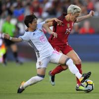 Yuka Momiki (left) and the United States’ Megan Rapinoe vie for the ball during their match on Thursday in Carson, California. The U.S. beat Japan 3-0. Japan falls against U.S. to finish winless at inaugural Tournament of Nations