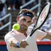 Roger Federer hits a return during his match against Robin Hasse in the semifinals of the Rogers Cup on Saturday in Montreal. Federer won 6-3, 7-6 (7-5) Federer reaches Rogers Cup final