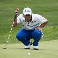 Hideki Matsuyama lines up a putt on the 15th hole during the final round of the Bridgestone Invitational on Sunday in Akron, Ohio. Confident Matsuyama turns thoughts to year's final major