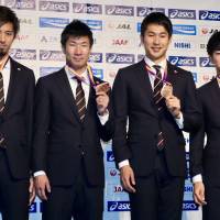 (From left) Kenji Fujimitsu, Yoshihide Kiryu, Shota Iizuka and Shuhei Tada, who comprised Japan’s 4×100 relay team that earned the bronze medal at the world championships in London, pose for photos at Haneda airport on Tuesday. Relay team proud of 4x100 bronze