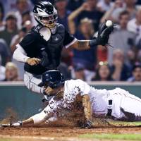 Boston shortstop Xander Bogaerts, seen here scoring against the Chicago White Sox last week, is just one of the young guns who have helped power the Red Sox into first place in the AL East. | AP