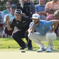 Hideki Matsuyama (left) and Dustin Johnson line up their putts on the 14th hole during the first round of the Birdgestone Invitational on Thursday in Akron, Ohio. Matsuyama four shots back after first round of Bridgestone Invitational