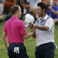 Justin Thomas (left) and Hideki Matsuyama of Japan wrap up their final round of the PGA Championship golf tournament at the Quail Hollow Club Sunday in Charlotte, North Carolina. | AP