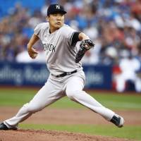 New York starter Masahiro Tanaka pitches against Toronto in the first inning on Wednesday night. Tanaka faces Aoki, gets no-decision