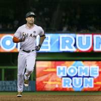 Miami slugger Giancarlo Stanton rounds the bases after hitting a home run against Colorado in the sixth inning on Friday night. Sizzling Stanton slugs 40th HR
