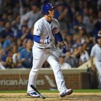 Chicago’s Anthony Rizzo watches his home run against Cincinnati in the fourth inning leave the yard on Monday. Big boppers Bryant, Rizzo power Cubs in rout of Reds