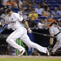 Miami’s Giancarlo Stanton watches the ball after hitting a solo homer in the fourth inning against the Giants on Tuesday. Stanton keeps homer streak alive before Marlins cough up late lead