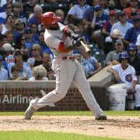 Cincinnati’s Phillip Ervin blasts a two-run homer against the Cubs in the seventh inning on Thursday in Chicago. Reds jump out to 9-0 lead, hold off Cubs in slugfest