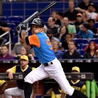 The Marlins’ Ichiro Suzuki strokes a pinch-hit single in the seventh inning on Saturday against the Padres in Miami. Ichiro breaks team mark for pinch-hits in year