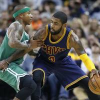 A trade that would send Cavaliers guard Kyrie Irving (right) to Boston and Celtics guard Isaiah Thomas is in limbo as the Cavs review Thomas’ health. Cavs looking over trade after Thomas has physical