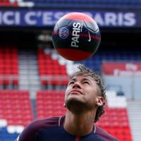 Paris Saint-Germain’s Neymar heads a ball during his official presentation at Parc des Princes stadium in Paris on Friday. Neymar to miss French league opener because of paperwork issues