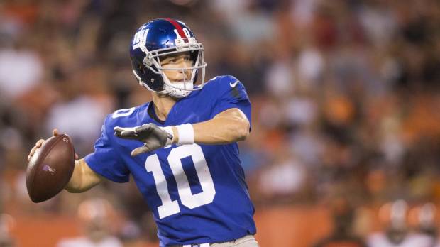 New York QB Eli Manning looks down field to pass against Cleveland in the first quarter on Monday night. Beckham injured as Giants fall to Browns